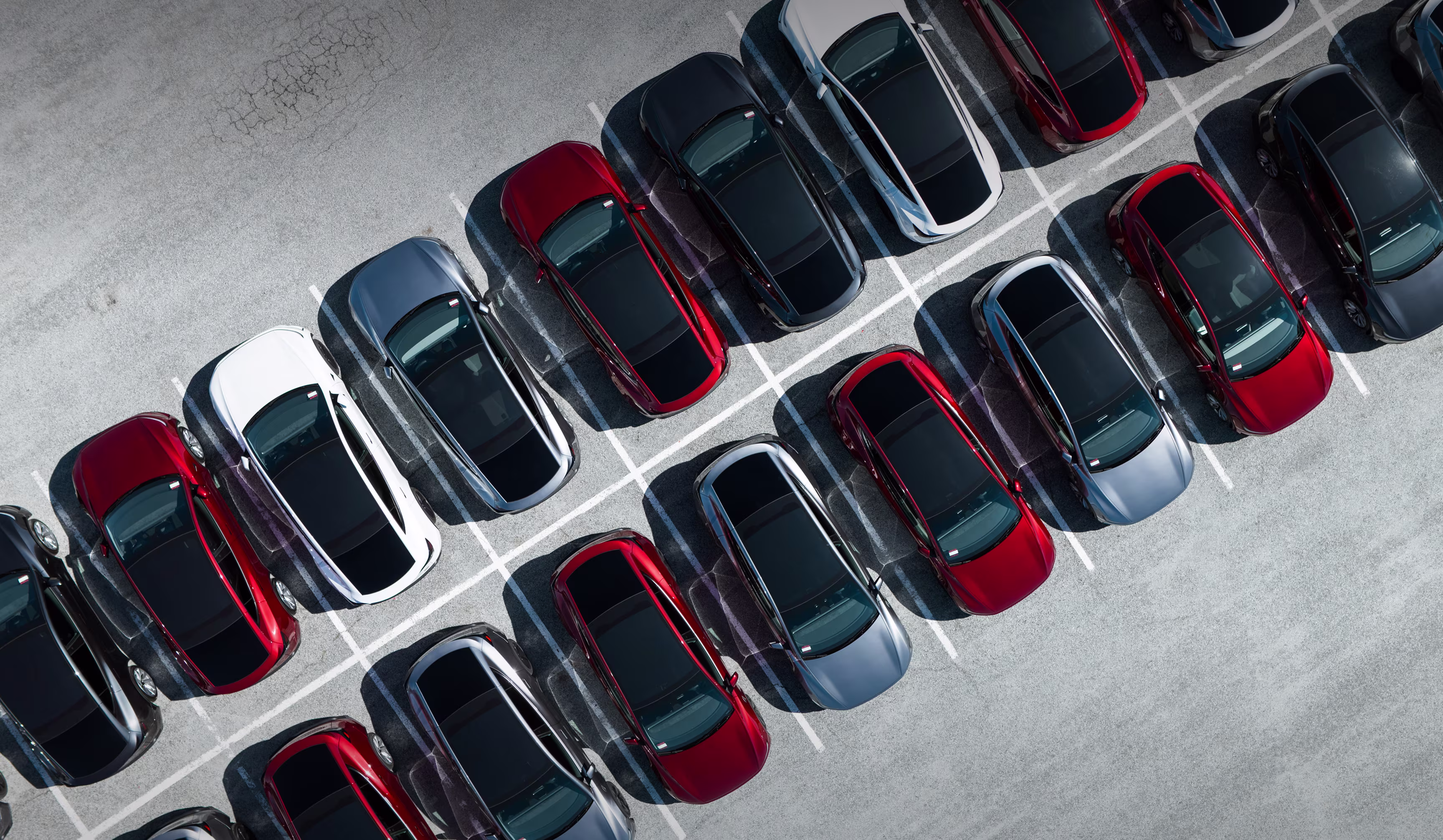 Birds eye view of Tesla vehicles parking in a parking lot