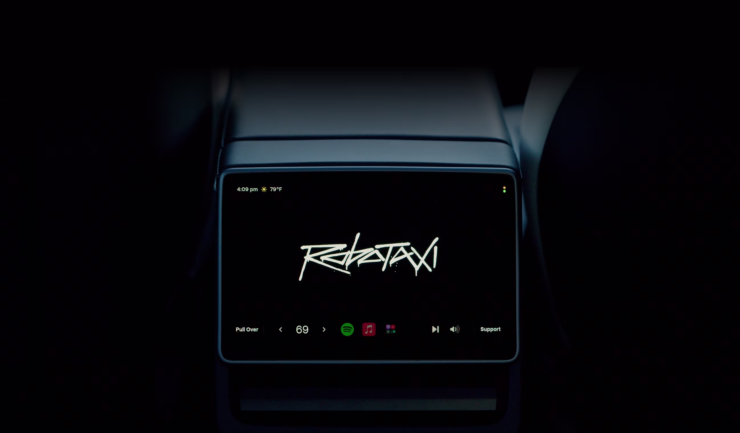 The rear seat screen inside a Robotaxi displaying the time, weather, vehicle temperature, apps and support options.