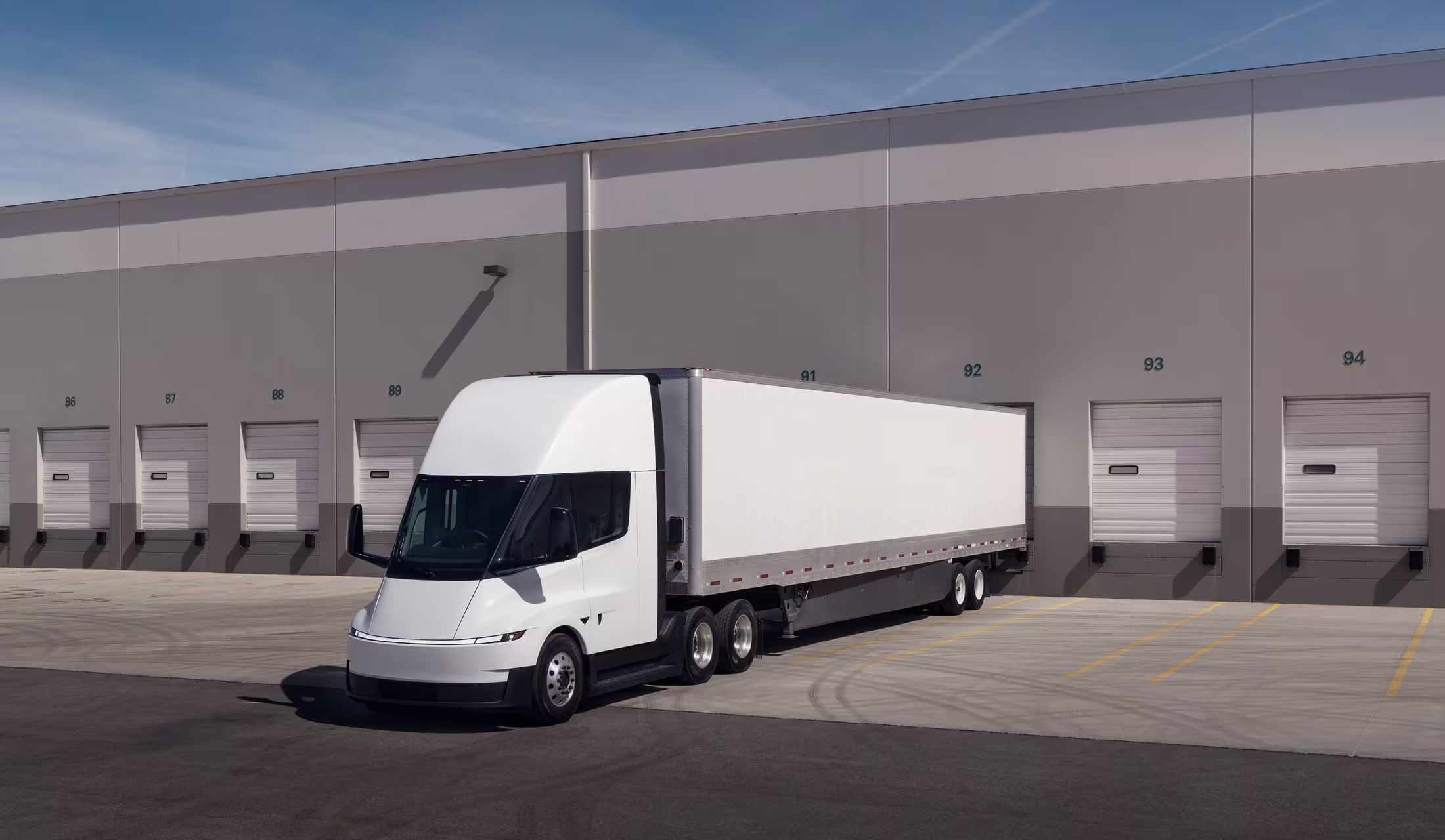 Electric Semi truck parked in front of a warehouse